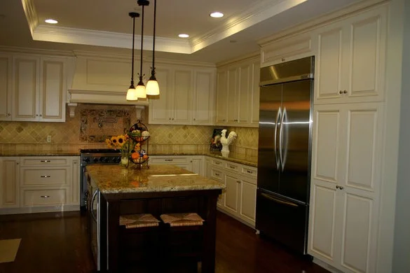 Cream cabinet kitchen with a stone island, similar to Redwood City kitchen remodels we build