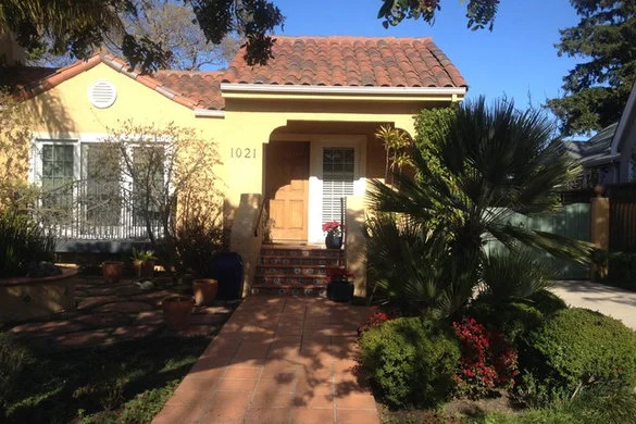 Spanish-style house with a clay tile roof and a tiled entry walk